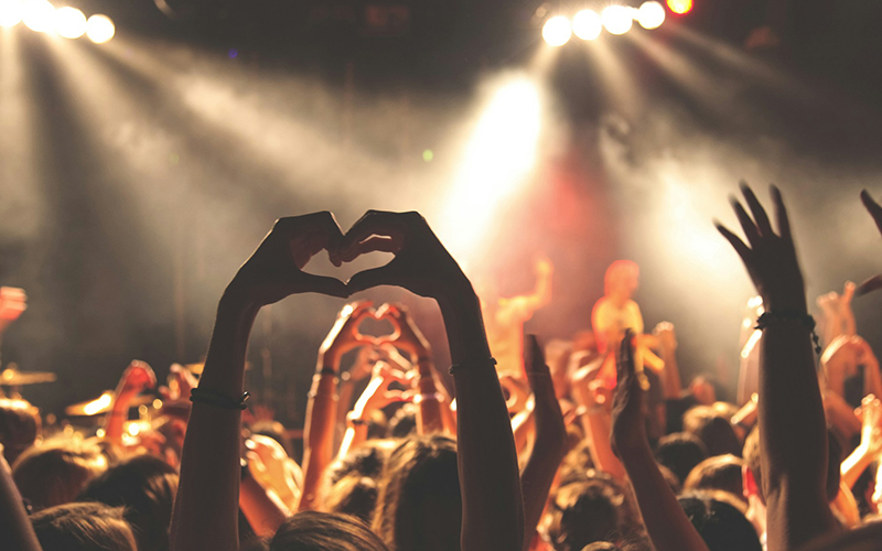 Get-Tickets-2 Concert experience with hands in the air making a heart shape